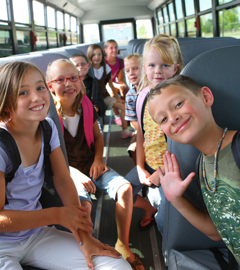 smiling children on a school bus
