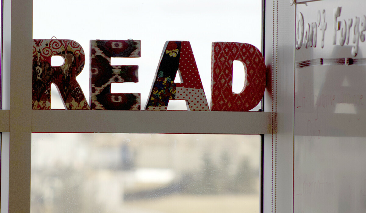 The word READ in all capital letters, displayed on a window ledge.