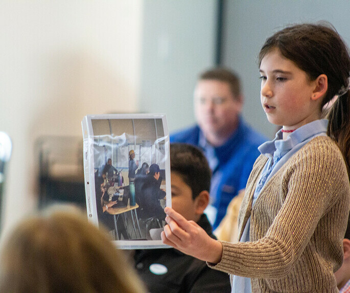 Student holding up photo